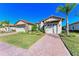 Two-story house with tile roof, two-car garage, and landscaped yard at 1810 5Th E St, Palmetto, FL 34221
