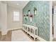 Elegant hallway with geometric wallpaper and console table at 1810 5Th E St, Palmetto, FL 34221