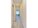 Bright hallway with carpeted floors leading to bedrooms at 1810 5Th E St, Palmetto, FL 34221