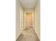 Bright hallway with carpeted flooring and access to bedrooms at 1810 5Th E St, Palmetto, FL 34221