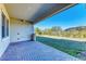 Covered patio with brick flooring and access to grassy backyard at 1810 5Th E St, Palmetto, FL 34221