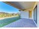 Covered patio with brick flooring and access to grassy backyard at 1810 5Th E St, Palmetto, FL 34221