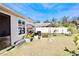 Large backyard with a covered patio, providing shade and a relaxing outdoor space at 2111 Tally Breeze Way, Bradenton, FL 34208