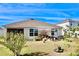 Spacious backyard with a patio cover, garden, and ample space for outdoor activities at 2111 Tally Breeze Way, Bradenton, FL 34208