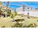 Landscaped backyard with young fruit trees and a view of neighboring homes at 2111 Tally Breeze Way, Bradenton, FL 34208