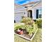 Landscaped front yard with colorful flowers at 2111 Tally Breeze Way, Bradenton, FL 34208