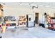 Organized garage with workbench, shelving, and a refrigerator at 2111 Tally Breeze Way, Bradenton, FL 34208