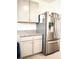 Kitchen with stainless steel refrigerator and granite countertops at 2111 Tally Breeze Way, Bradenton, FL 34208