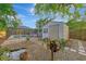 Landscaped backyard with a shed and a pond at 2708 Bigelow Dr, Sarasota, FL 34239