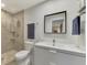 Modern bathroom with a large vanity, shower, and toilet at 2708 Bigelow Dr, Sarasota, FL 34239