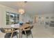 Dining area with round wooden table, chandelier, and four chairs at 2708 Bigelow Dr, Sarasota, FL 34239