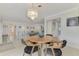 Bright dining room with a round table and modern chandelier at 2708 Bigelow Dr, Sarasota, FL 34239