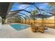 Enclosed rectangular pool with a patio and seating area at 2708 Bigelow Dr, Sarasota, FL 34239