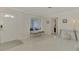 Entryway with white door, bench, and large window at 2708 Bigelow Dr, Sarasota, FL 34239