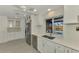 Kitchen with stainless steel appliances and white cabinets, overlooking pool at 2708 Bigelow Dr, Sarasota, FL 34239