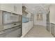 Modern kitchen with stainless steel appliances and white cabinets at 2708 Bigelow Dr, Sarasota, FL 34239