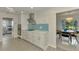 Modern white kitchen with stainless steel appliances and light blue backsplash at 2708 Bigelow Dr, Sarasota, FL 34239