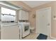 Laundry room with washer, dryer, and cabinets at 2708 Bigelow Dr, Sarasota, FL 34239