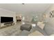 Open living area with grey sectional sofa, dining area, and TV at 2708 Bigelow Dr, Sarasota, FL 34239