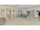Bright living room with a grey sectional sofa and view of bathroom at 2708 Bigelow Dr, Sarasota, FL 34239