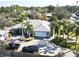 Single-Gathering home with a large driveway, two cars, and lush landscaping at 3011 Ashton Rd, Sarasota, FL 34231