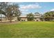 Spacious backyard with lush grass and mature trees at 3011 Ashton Rd, Sarasota, FL 34231