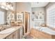 Elegant bathroom with double vanity and a large corner soaking tub at 3011 Ashton Rd, Sarasota, FL 34231
