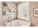 Bathroom with corner soaking tub, glass block window, and decorative accents at 3011 Ashton Rd, Sarasota, FL 34231