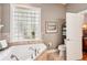 Relaxing bathroom with soaking tub and glass block window at 3011 Ashton Rd, Sarasota, FL 34231