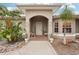 Front entrance with a charming wooden door, brick pathway, and lush landscaping at 3011 Ashton Rd, Sarasota, FL 34231