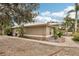 House exterior showcasing a landscaped yard and metal roof at 3011 Ashton Rd, Sarasota, FL 34231