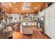 Open kitchen with island, stainless steel appliances, and wood ceiling at 3011 Ashton Rd, Sarasota, FL 34231