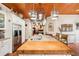Island kitchen with stainless steel appliances and a wood-beamed ceiling at 3011 Ashton Rd, Sarasota, FL 34231