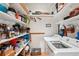 Laundry room with washer, dryer and ample storage shelves at 3011 Ashton Rd, Sarasota, FL 34231