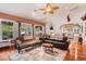 Living room with hardwood floors, comfortable seating, and large windows at 3011 Ashton Rd, Sarasota, FL 34231