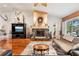 Living room featuring a stone fireplace, hardwood floors, and comfortable furniture at 3011 Ashton Rd, Sarasota, FL 34231