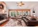 Living area with hardwood floors, comfortable seating, and a stone fireplace at 3011 Ashton Rd, Sarasota, FL 34231