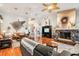 Open living space with hardwood floors, leather furniture, and a stone fireplace at 3011 Ashton Rd, Sarasota, FL 34231