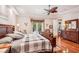 Main bedroom with king-size bed, hardwood floors, and access to backyard at 3011 Ashton Rd, Sarasota, FL 34231