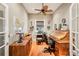 Home office with built-in desk, hardwood floors, and ample natural light at 3011 Ashton Rd, Sarasota, FL 34231