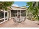 Inviting patio with brick pavers and a metal table set at 3011 Ashton Rd, Sarasota, FL 34231