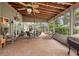 Spacious screened patio with brick pavers, outdoor furniture, and a grill at 3011 Ashton Rd, Sarasota, FL 34231