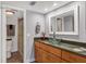 Bathroom with glass sink and light wood cabinets at 3300 S Beneva Rd # 224, Sarasota, FL 34232