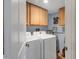 Convenient laundry room with washer, dryer, and storage cabinets at 3300 S Beneva Rd # 224, Sarasota, FL 34232