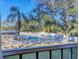 Community pool with surrounding patio furniture and lush landscaping at 3300 S Beneva Rd # 224, Sarasota, FL 34232