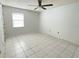 Simple bedroom with tile floors and a window at 3750 59Th W Ave # 4096, Bradenton, FL 34210