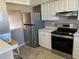 Stainless steel appliances and white cabinets in condo kitchen at 3983 Maceachen Blvd # 432, Sarasota, FL 34233