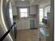 White kitchen cabinets, stainless steel appliances and microwave at 3983 Maceachen Blvd # 432, Sarasota, FL 34233