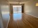 Spacious living room with hardwood floors and sliding glass doors at 3983 Maceachen Blvd # 432, Sarasota, FL 34233