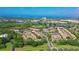 Aerial view of Pinestone community, featuring numerous buildings, lush landscaping, and a tennis court at 4275 Castlebridge Ln # 1312B1, Sarasota, FL 34238